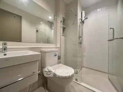 Modern bathroom with sleek fixtures and glass shower enclosure