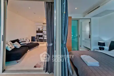 Modern open-plan living room and bedroom with stylish decor and natural light.