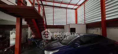 Spacious garage with modern staircase and ample natural light