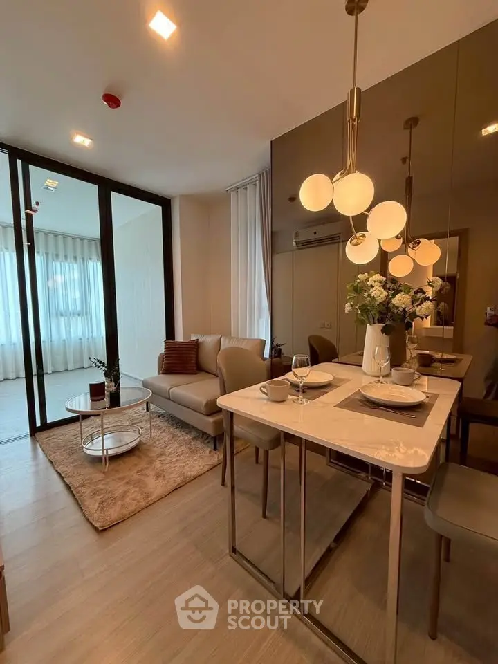 Modern living room with elegant dining area and stylish lighting in a cozy apartment.