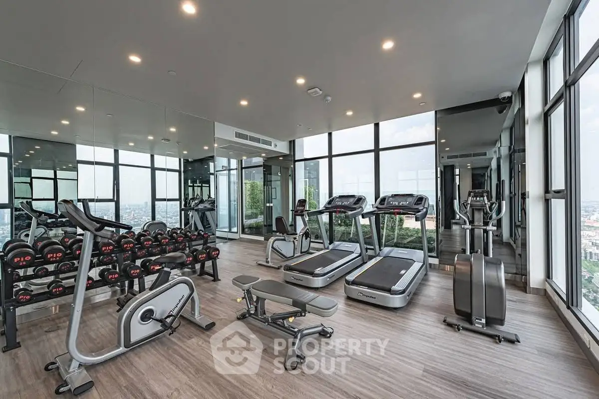 Modern high-rise gym with panoramic city views and state-of-the-art equipment.