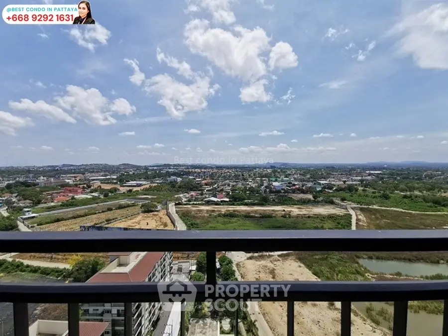 Stunning panoramic view from high-rise condo balcony in Pattaya with clear skies and lush landscape.
