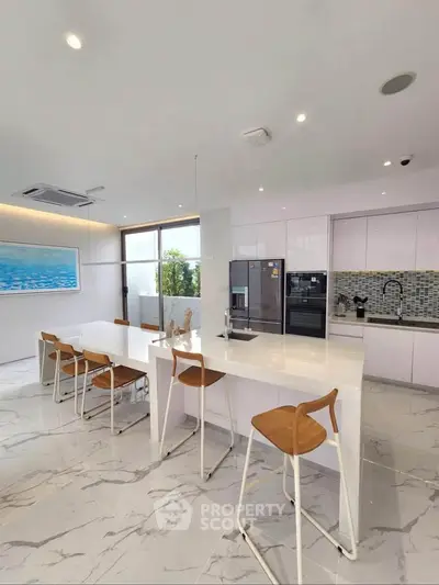 Modern kitchen with sleek design, marble flooring, and stylish bar seating