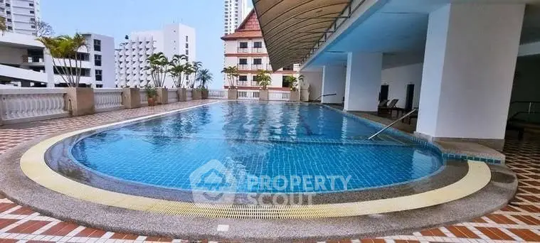 Luxurious rooftop pool with city views in a modern residential building.