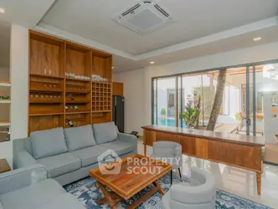 Luxurious living room with modern furniture and pool view, perfect for relaxation and entertainment.