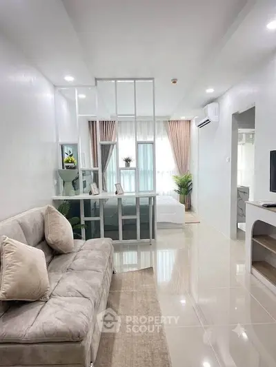 Modern open-plan living room with stylish partition and cozy decor