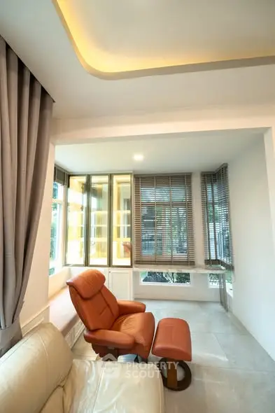 Modern living room with cozy seating and large windows