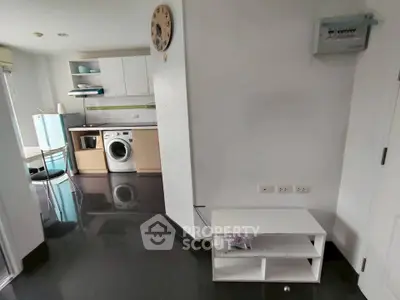 Modern kitchen with washing machine and sleek black flooring