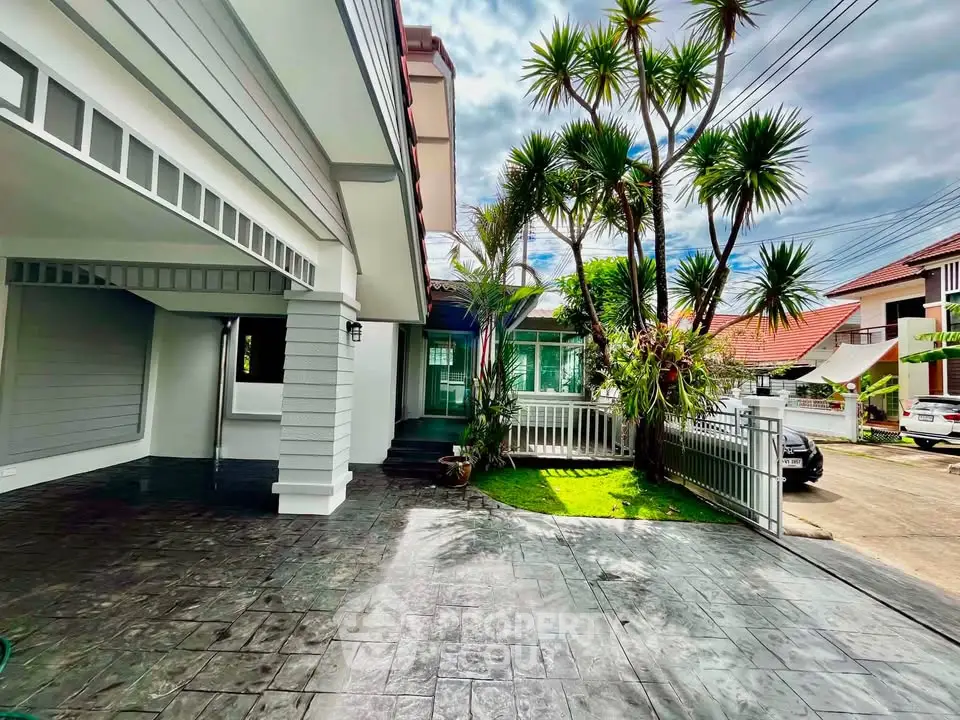 Stunning modern home exterior with lush garden and spacious driveway in a serene neighborhood.