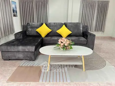 Stylish living room with modern gray sofa and vibrant yellow cushions