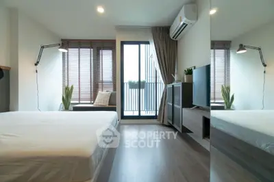 Modern bedroom with balcony access, featuring sleek design and ample natural light.