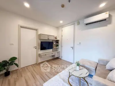 Modern living room with sleek furniture and wall-mounted TV, featuring cozy ambiance and stylish decor.