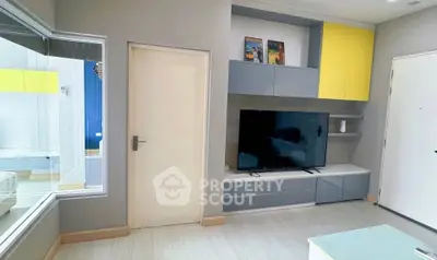 Modern living room with sleek TV unit and stylish cabinetry in a contemporary apartment.