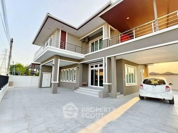 Modern two-story house with spacious driveway and balcony, perfect for family living.