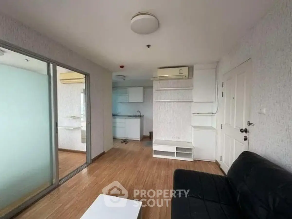 Modern living room with open kitchen and sleek design in urban apartment.