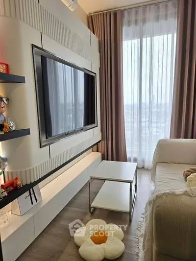 Modern living room with large TV, stylish shelving, and floor-to-ceiling window with city view.