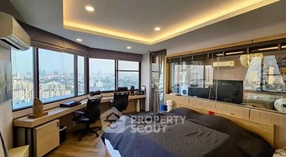 Luxurious bedroom with panoramic city views and modern workspace