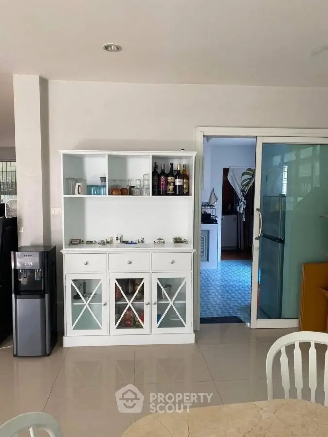 Spacious dining area with modern cabinet and sliding glass door