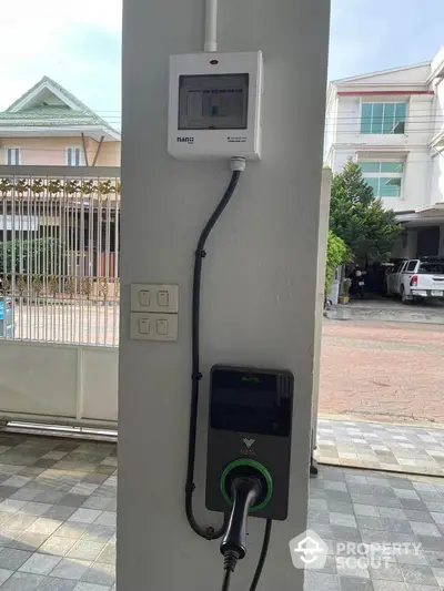 Modern electric vehicle charging station in residential driveway