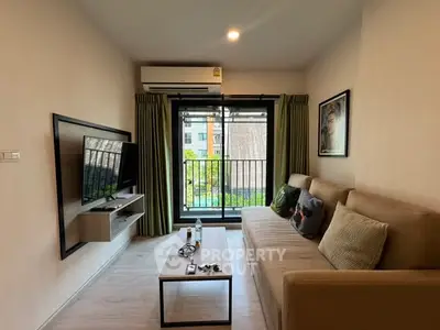 Modern living room with balcony view, featuring cozy sofa and wall-mounted TV in stylish apartment.
