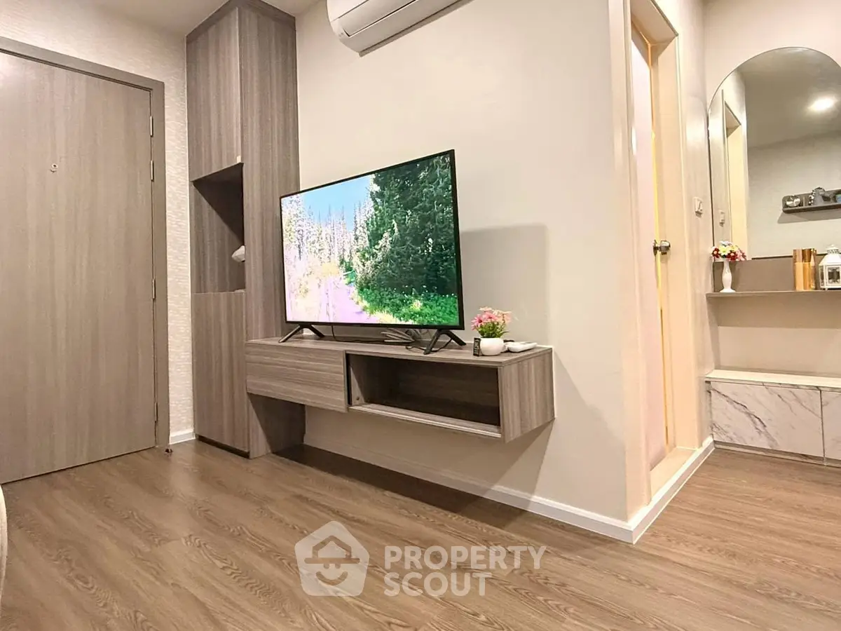 Modern living room with sleek TV setup and stylish wooden flooring