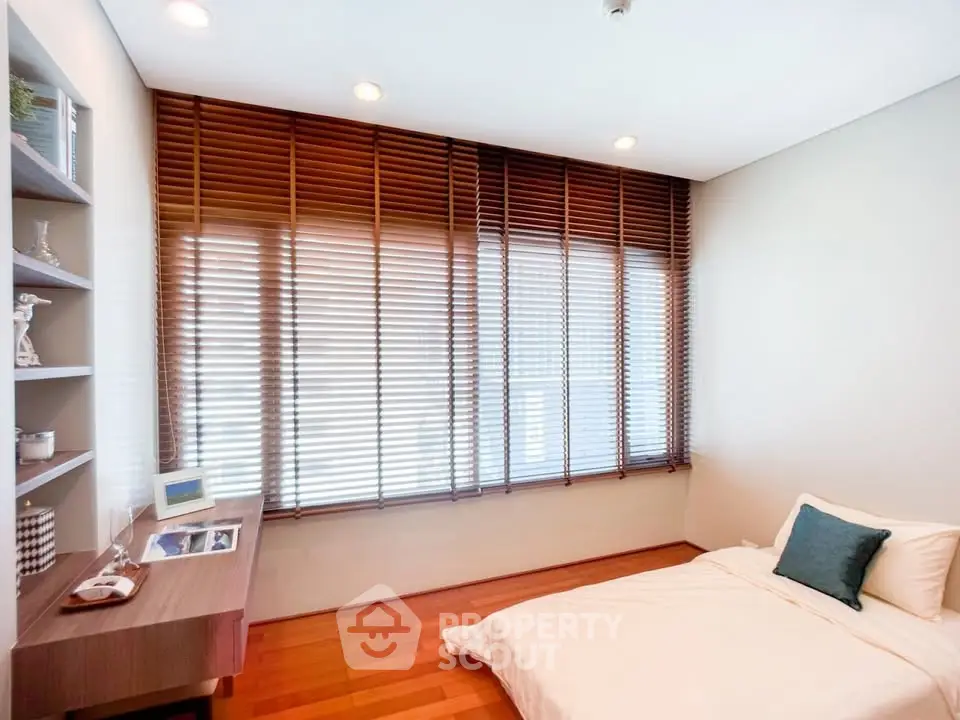 Modern minimalist bedroom with wooden blinds and cozy decor