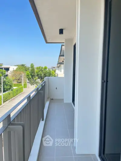 Spacious balcony with modern railing and scenic view in a contemporary home