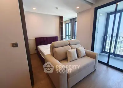 Modern bedroom with balcony view and cozy seating area