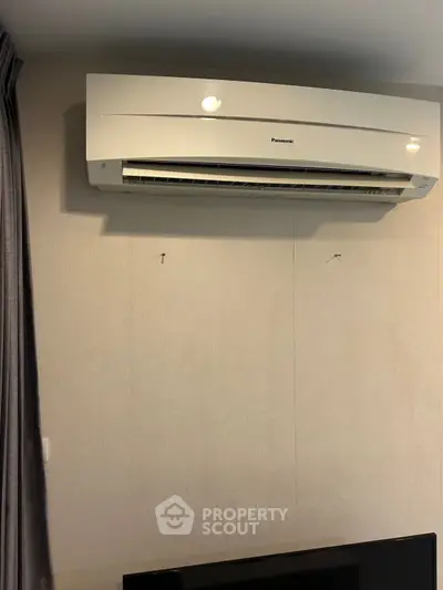 Modern air conditioning unit installed on a wall in a contemporary living space.