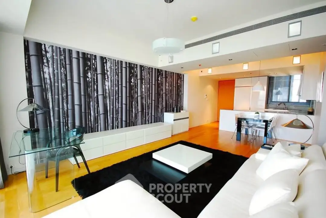 Modern living room with open kitchen, stylish decor, and sleek furniture in a contemporary apartment.