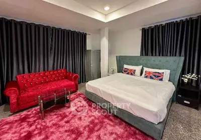 Luxurious bedroom with plush red sofa and elegant decor