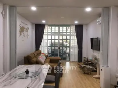 Spacious living room with modern decor and large windows for natural light.
