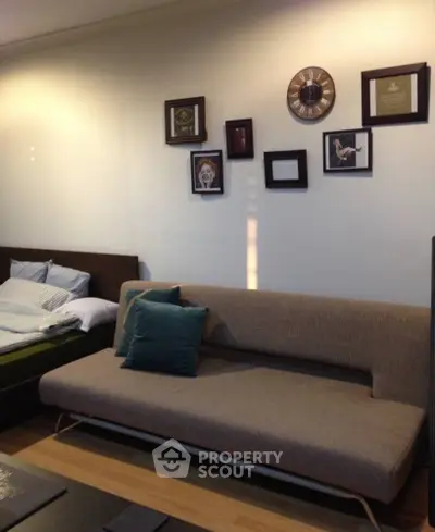 Cozy living room with modern sofa and wall art in stylish apartment