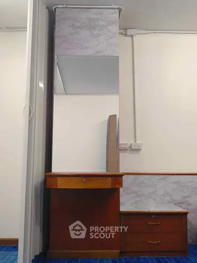 Elegant wooden vanity with mirror in a modern interior space