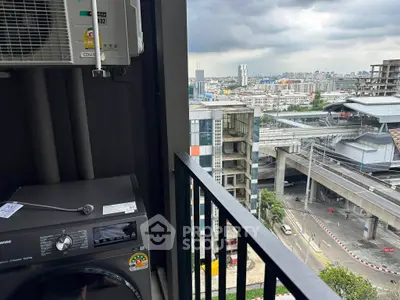 Urban balcony view with washing machine and cityscape backdrop, ideal for modern living.
