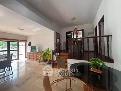 Spacious living room with natural light and elegant decor in a modern home.