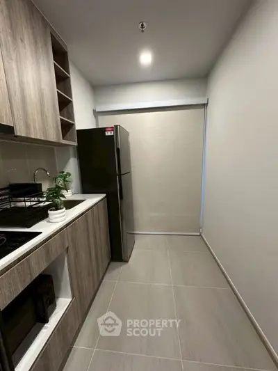 Modern kitchen with sleek cabinetry and stainless steel appliances in a compact layout.