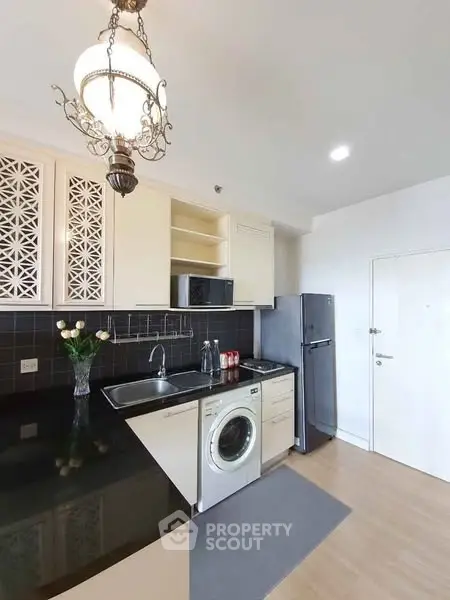 Modern kitchen with washing machine and elegant lighting