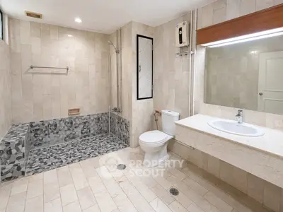 Spacious modern bathroom with elegant tile design and large mirror