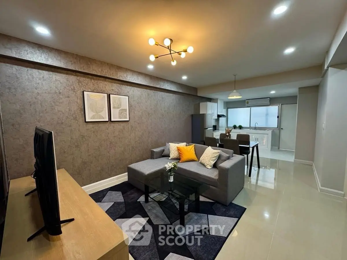 Modern living room with stylish decor and open kitchen layout