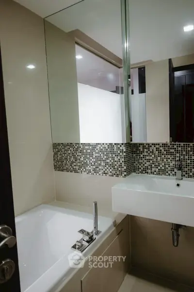 Modern bathroom with stylish mosaic tiles and sleek fixtures