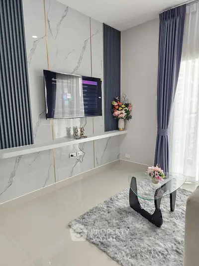 Modern living room with stylish decor and wall-mounted TV
