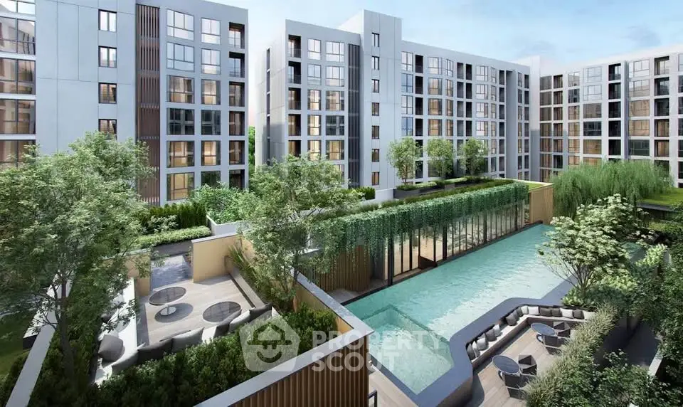 Modern apartment complex with lush greenery and inviting pool area.