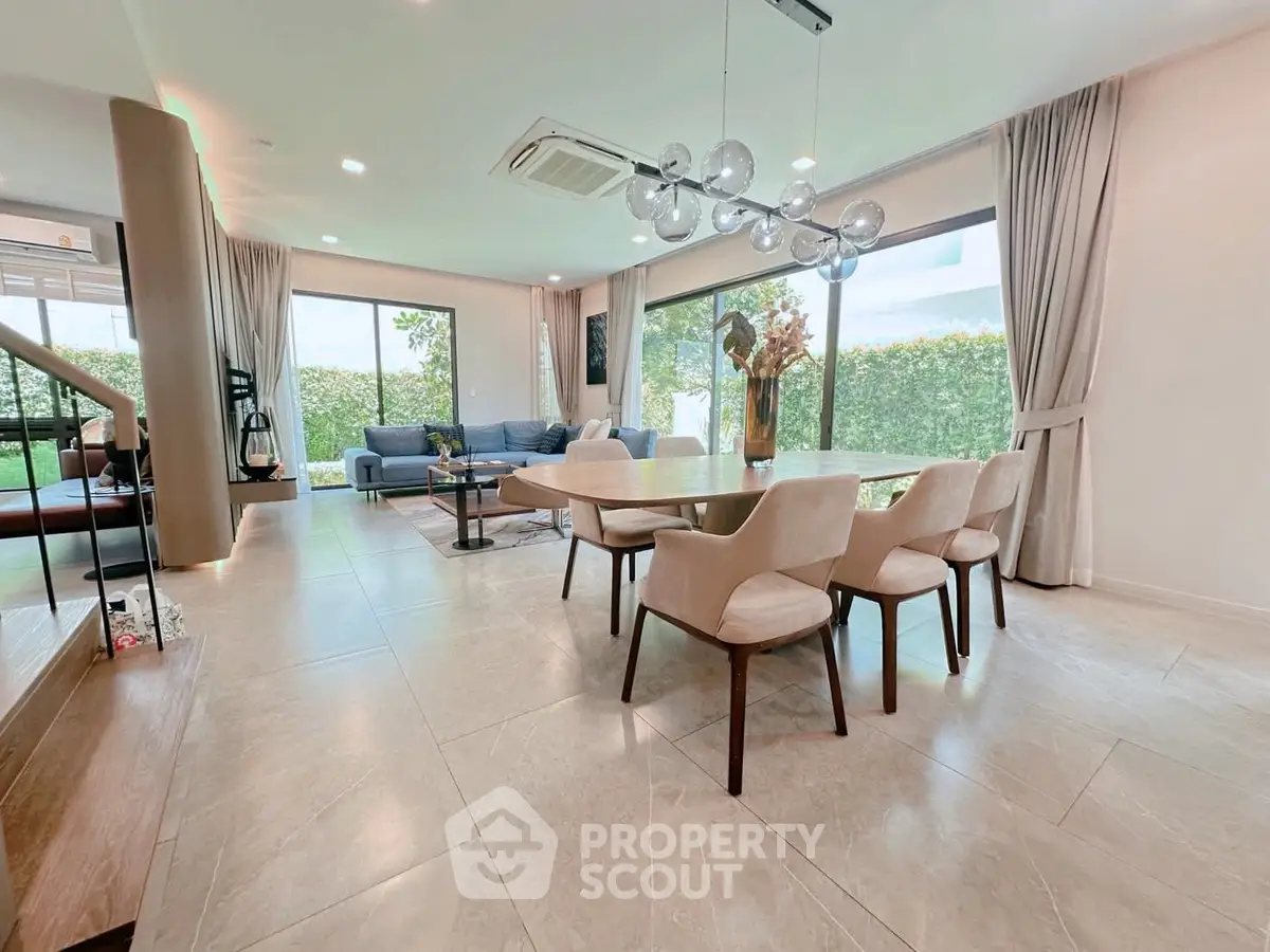 Spacious modern living and dining area with elegant decor and large windows.