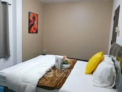 Cozy bedroom with modern decor and vibrant artwork, perfect for relaxation.