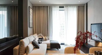 Modern living room with elegant decor and large windows