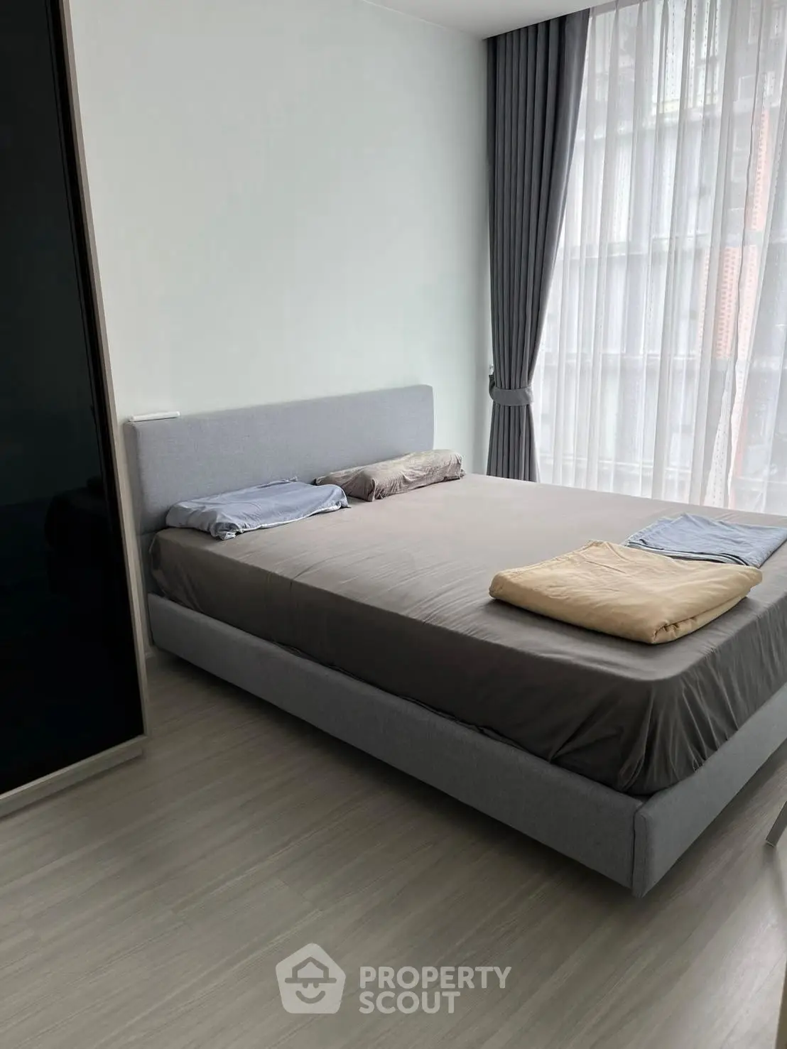 Modern bedroom with large window and minimalist decor