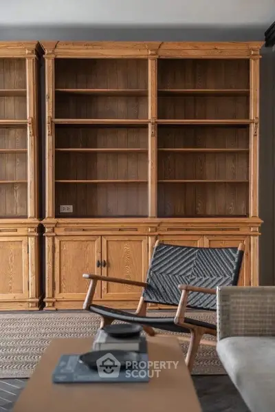 Elegant wooden shelving unit in a cozy living room setting with stylish furniture.