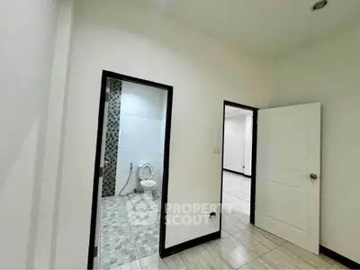 Spacious interior with modern bathroom and open doorway, perfect for customization.