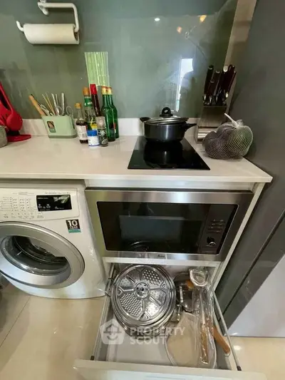 Modern kitchen with built-in appliances and sleek countertop design